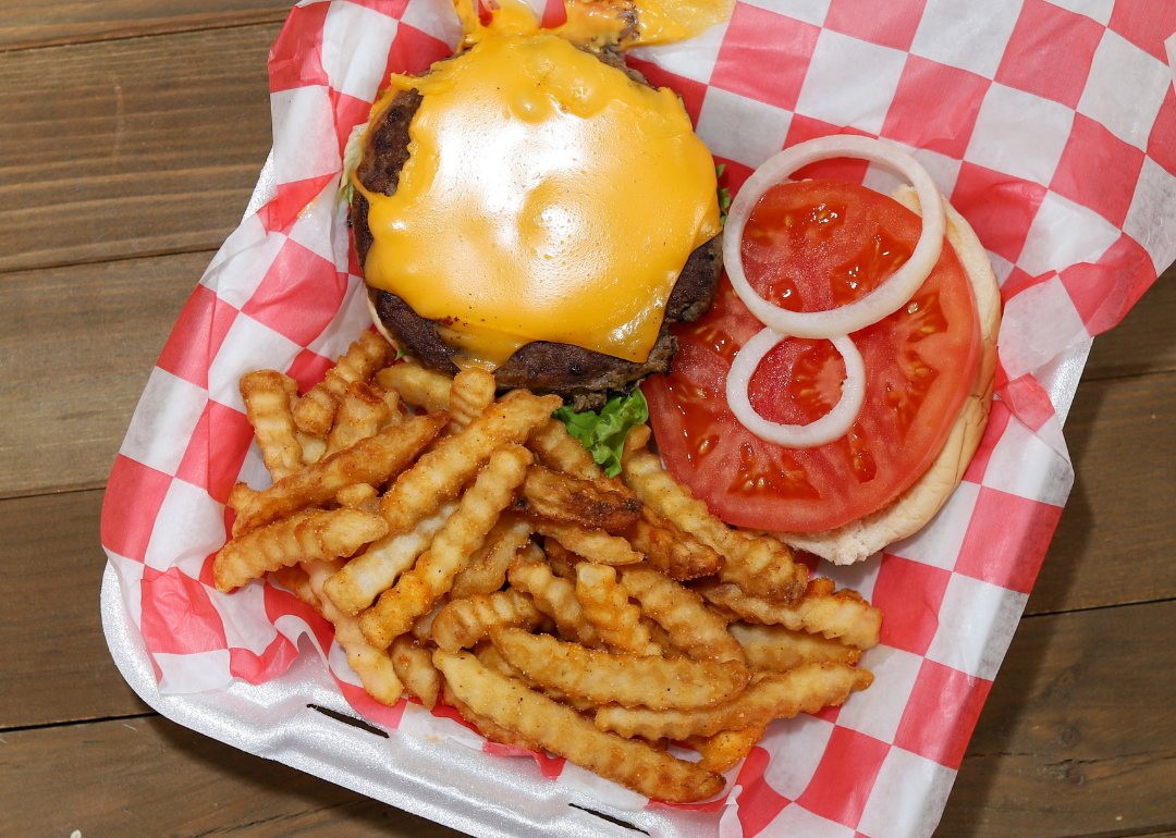 A takeout order of a cheeseburger and fries.