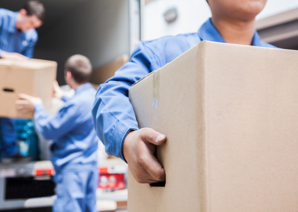 Movers unloading a truck of boxes