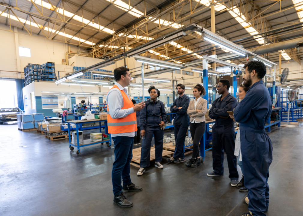 A manufacturing manager meets with his team