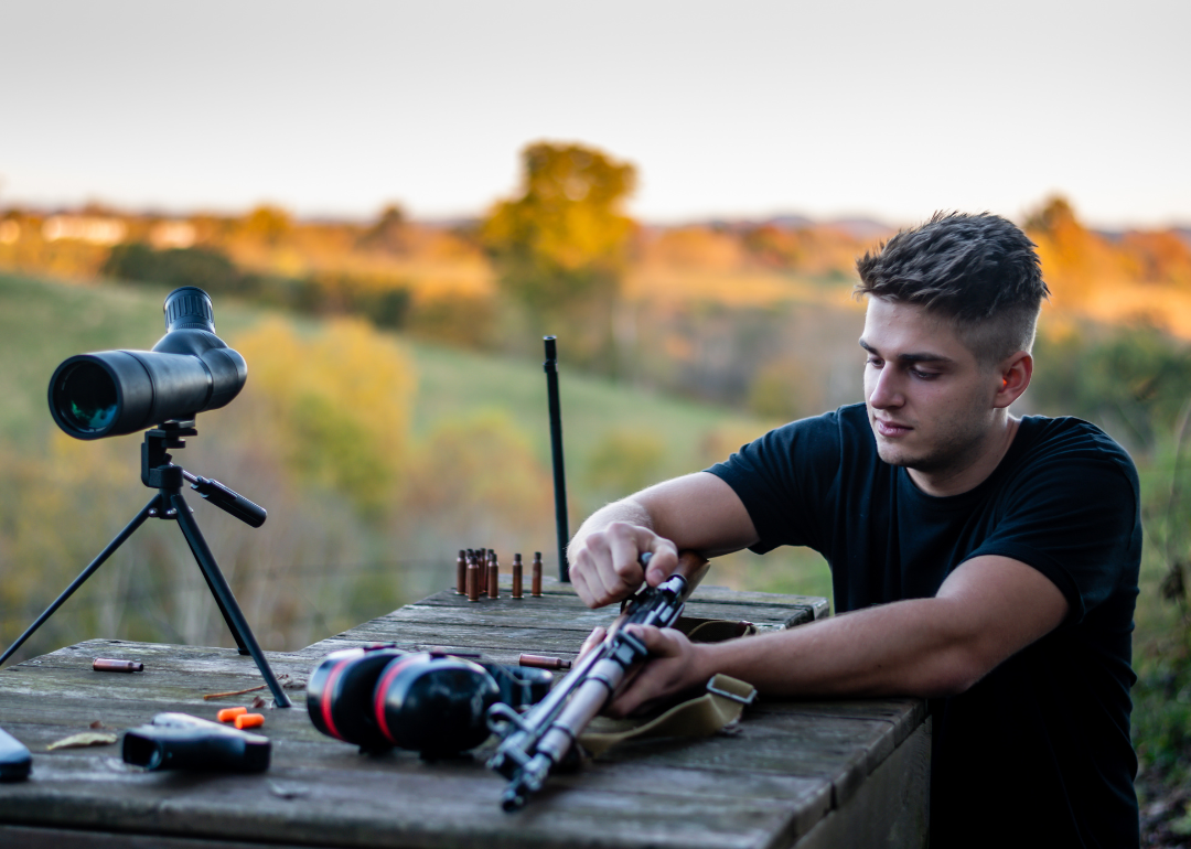 A person loading a rifle at an outdoor firing range in Kentucky.