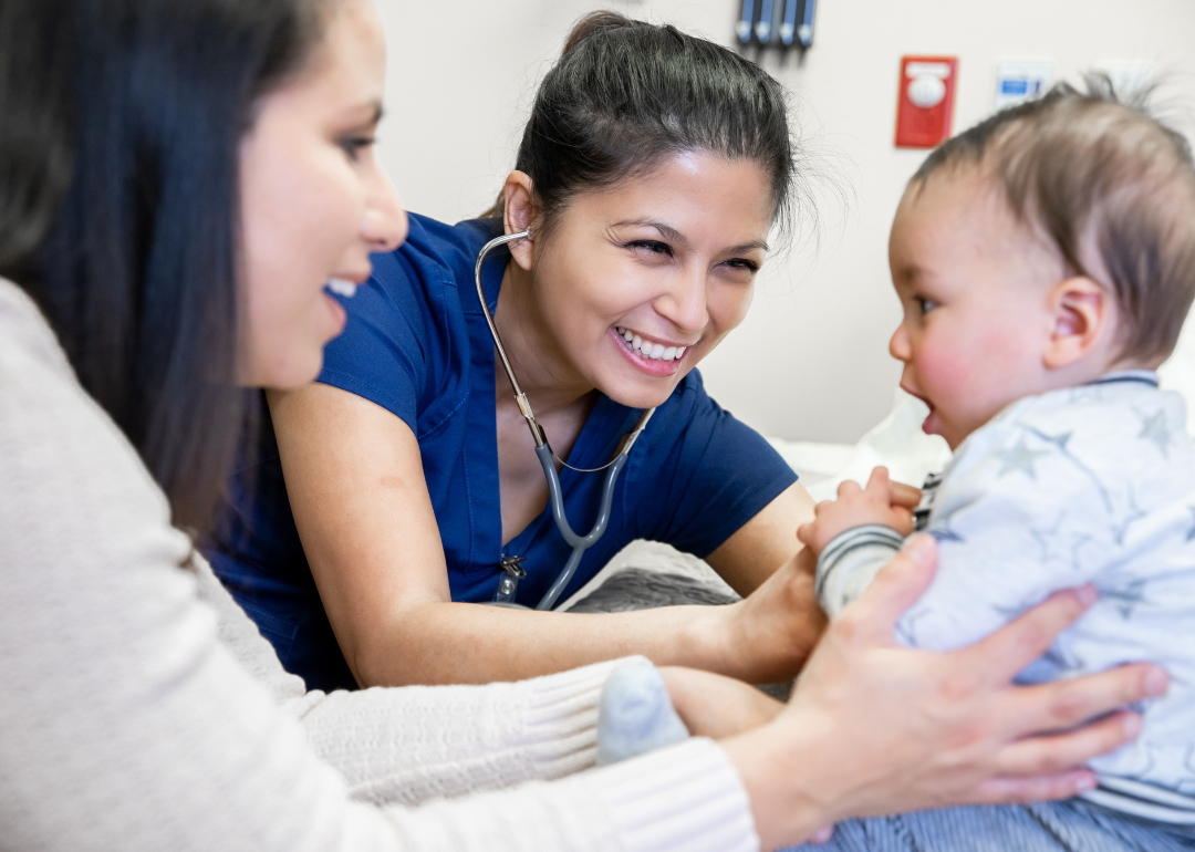 A nurse practitioner giving a baby boy a routine checkup.