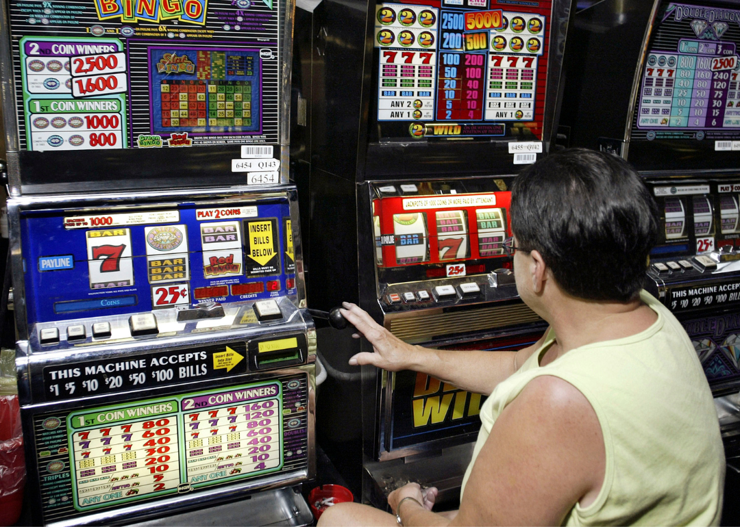 A person playing the quarter slots at the Two Rivers Casino and Resort.