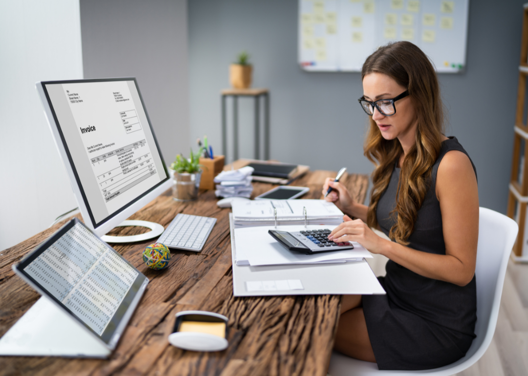 An accountant processing an invoice at their desk.