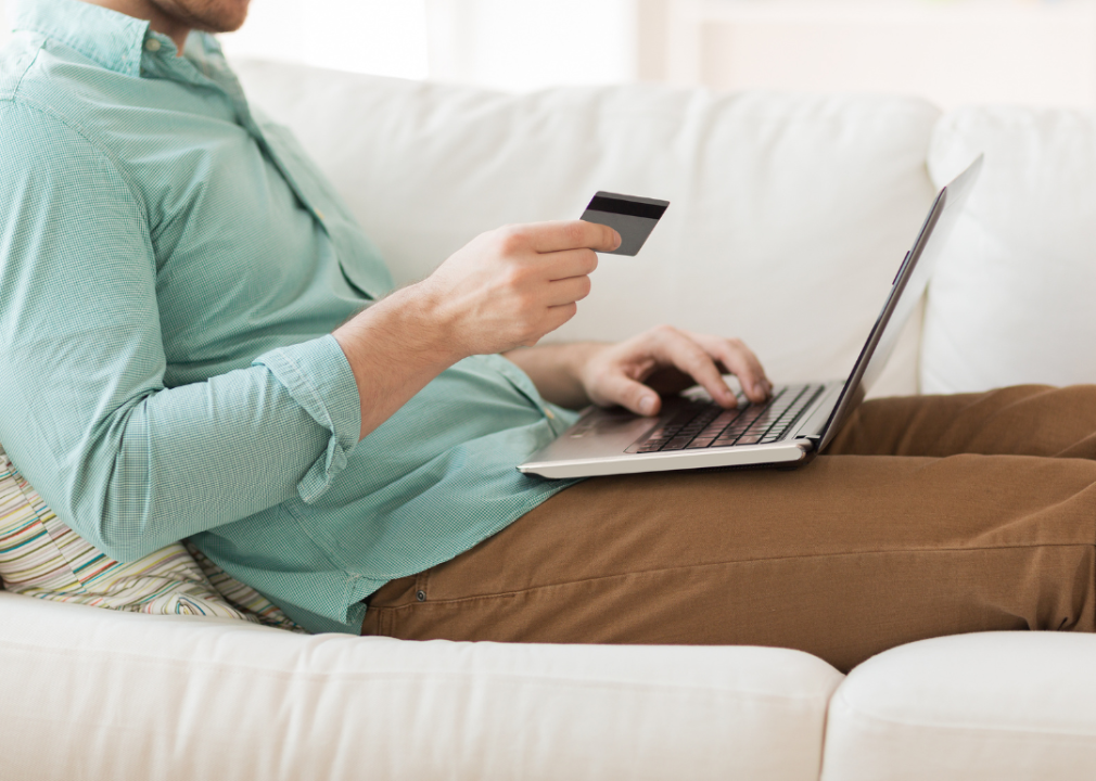 A man using his credit card to shop online