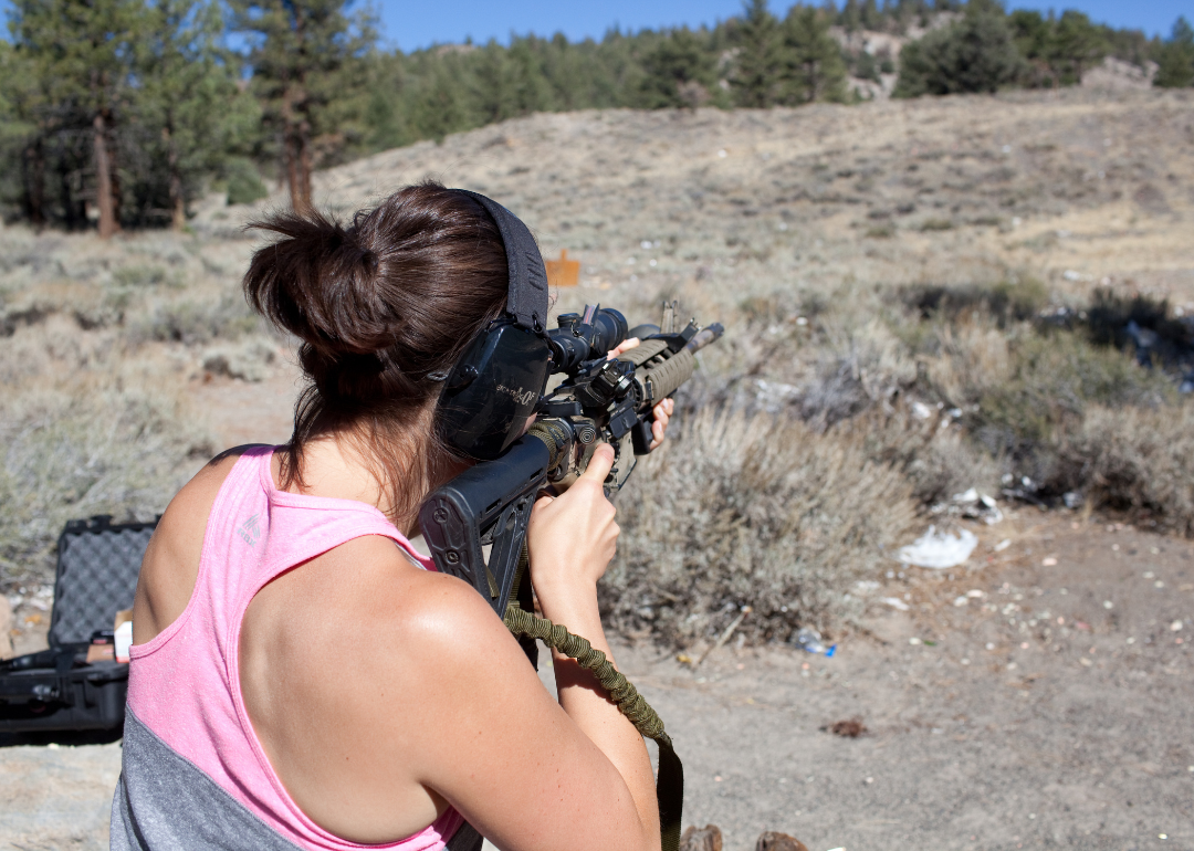 A person aiming a rifle at an outdoor shooting range in Mammoth Lakes.