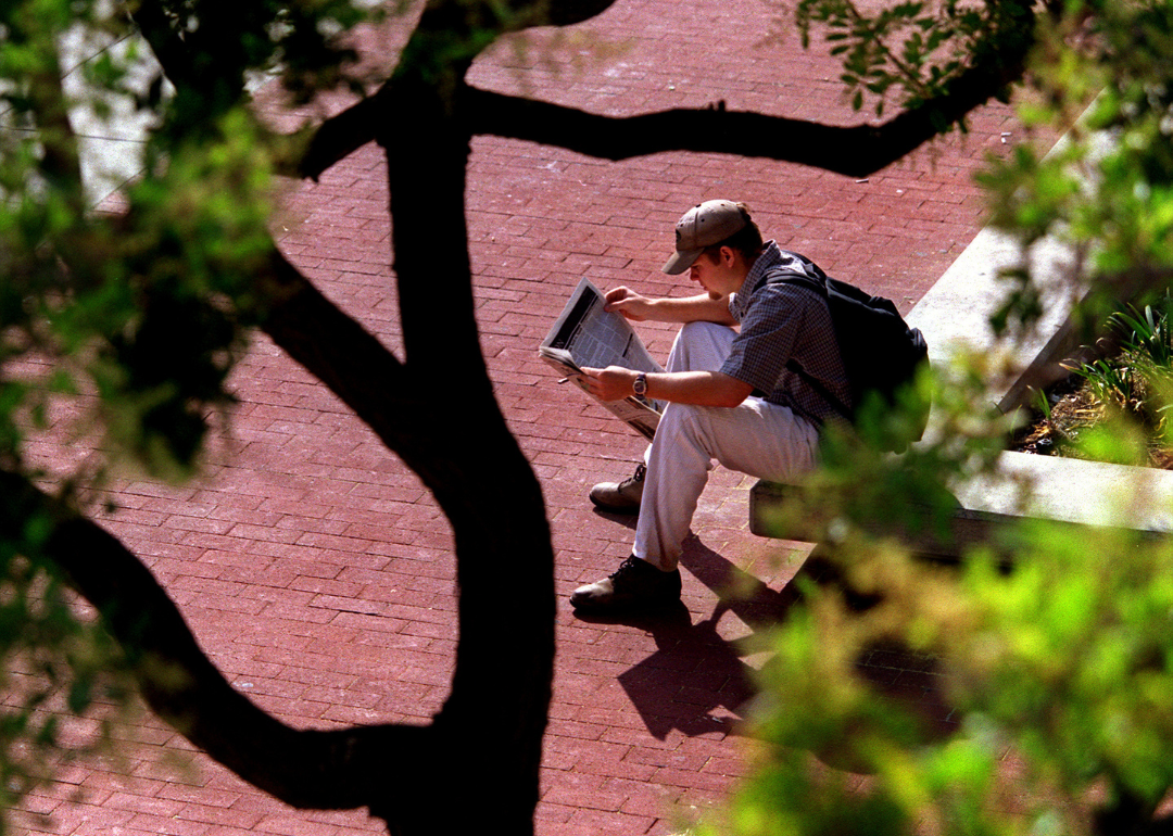 A student reading a university newspaper at the University of Irvine in 1998.