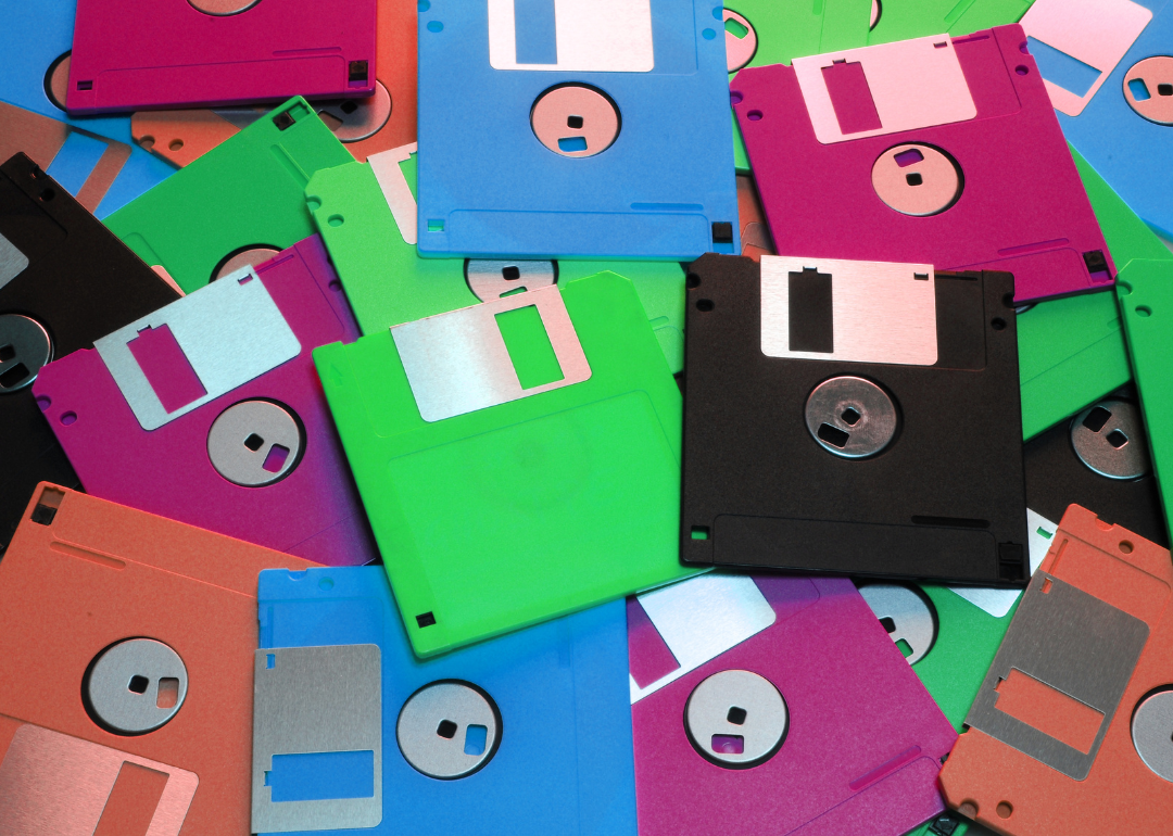 An assortment of brightly colored floppy disks on a table.