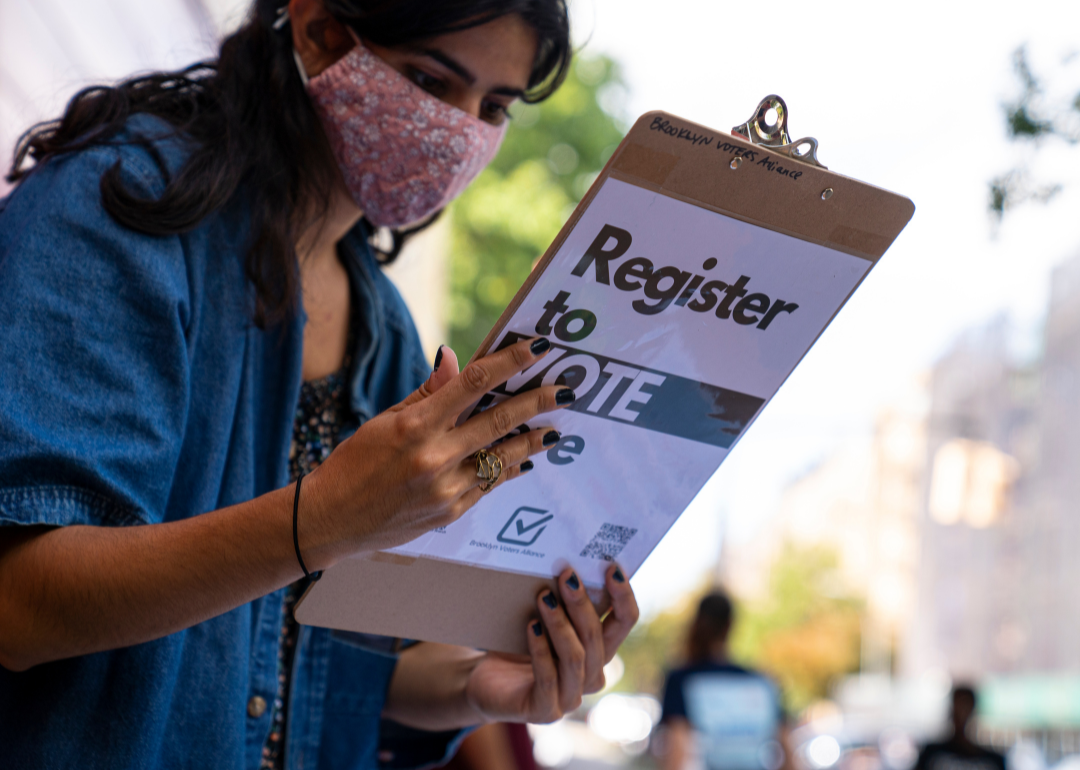 A volunteer from Brooklyn Voters Alliance checking a woman