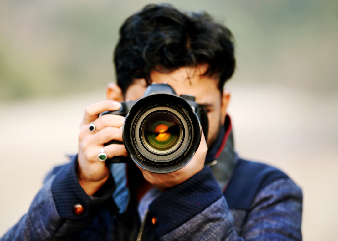 A photographer aims his lens at the camera.