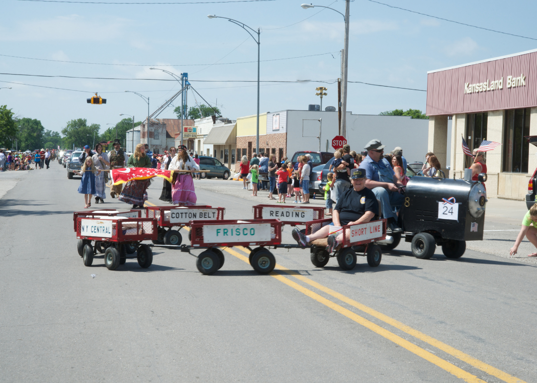 A miniature tractor train with one passenger during the annual Americus Days parade on Main Street (between Locust and Broadway streets), Americus, Kansas.