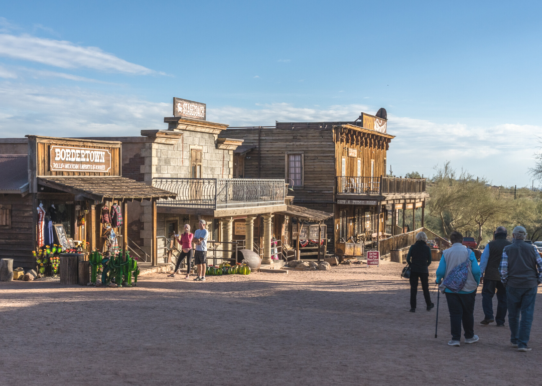 People walking along the buildings on Main Street in the old mining ghost town of Goldfield, Arizona.