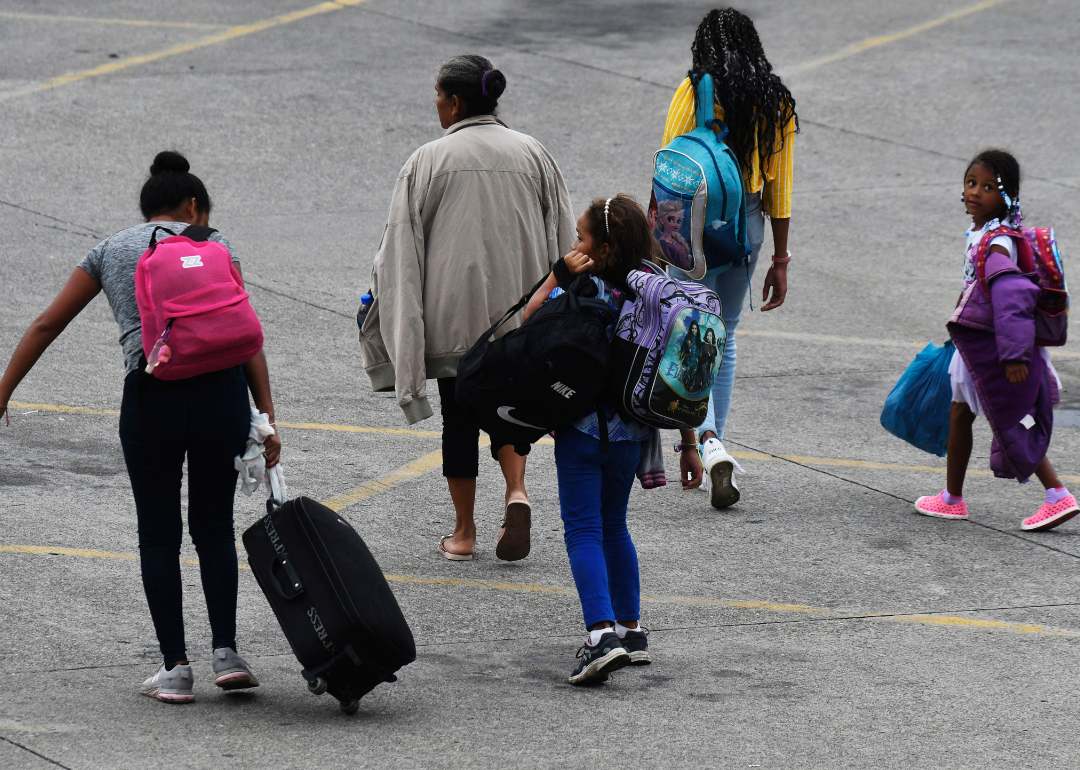 A family arriving at the Gran Central Metropolitana bus station, from where the migrant caravan will start its way to the US in San Pedro Sula, Honduras, on October 20, 2022.