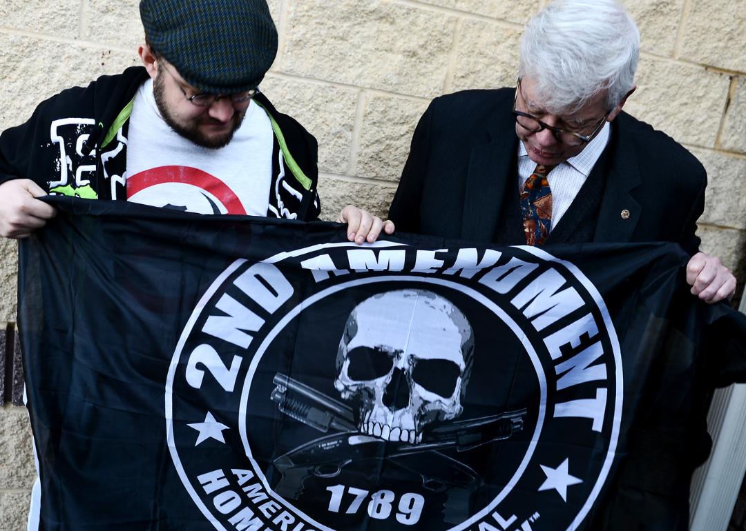 NRA President David Keene looking at a supporter's flag during a Delaware State Sportsmen's Association Second Amendment Rally in Dover.