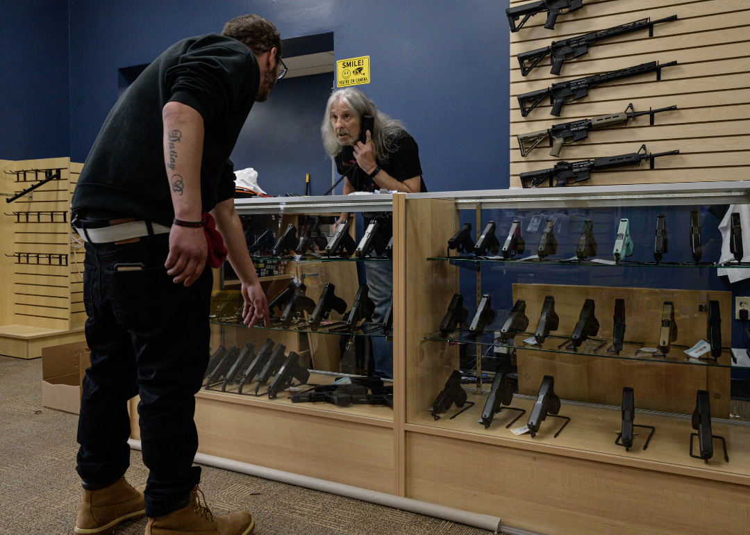 A customer browsing guns for sale at RTD Arms & Sport in Goffstown.