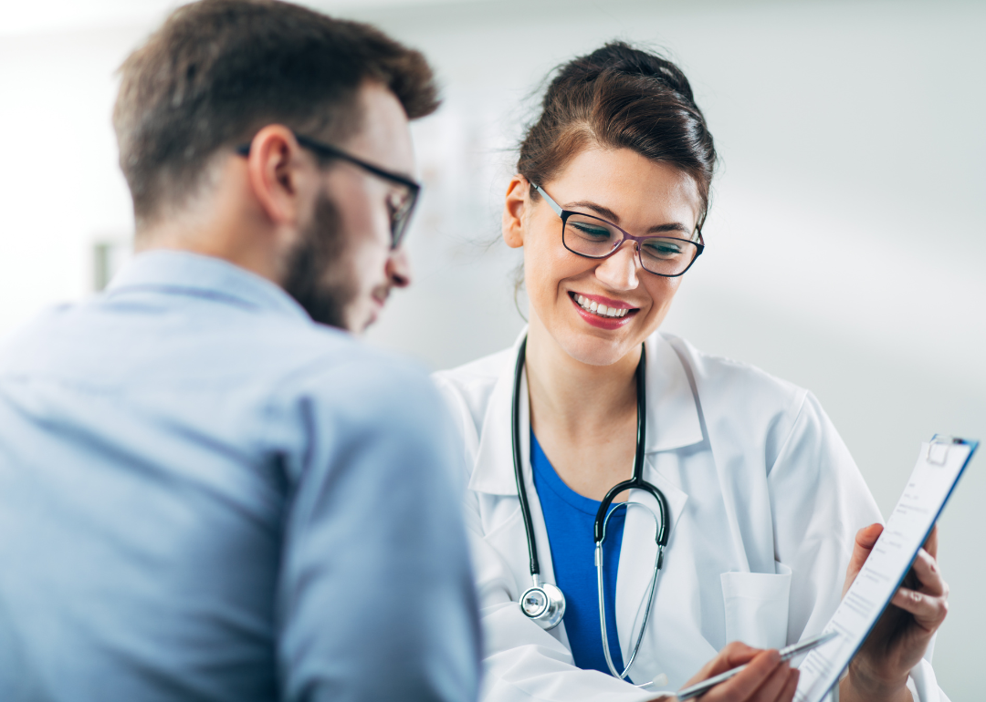 A medical worker speaks with a patient.