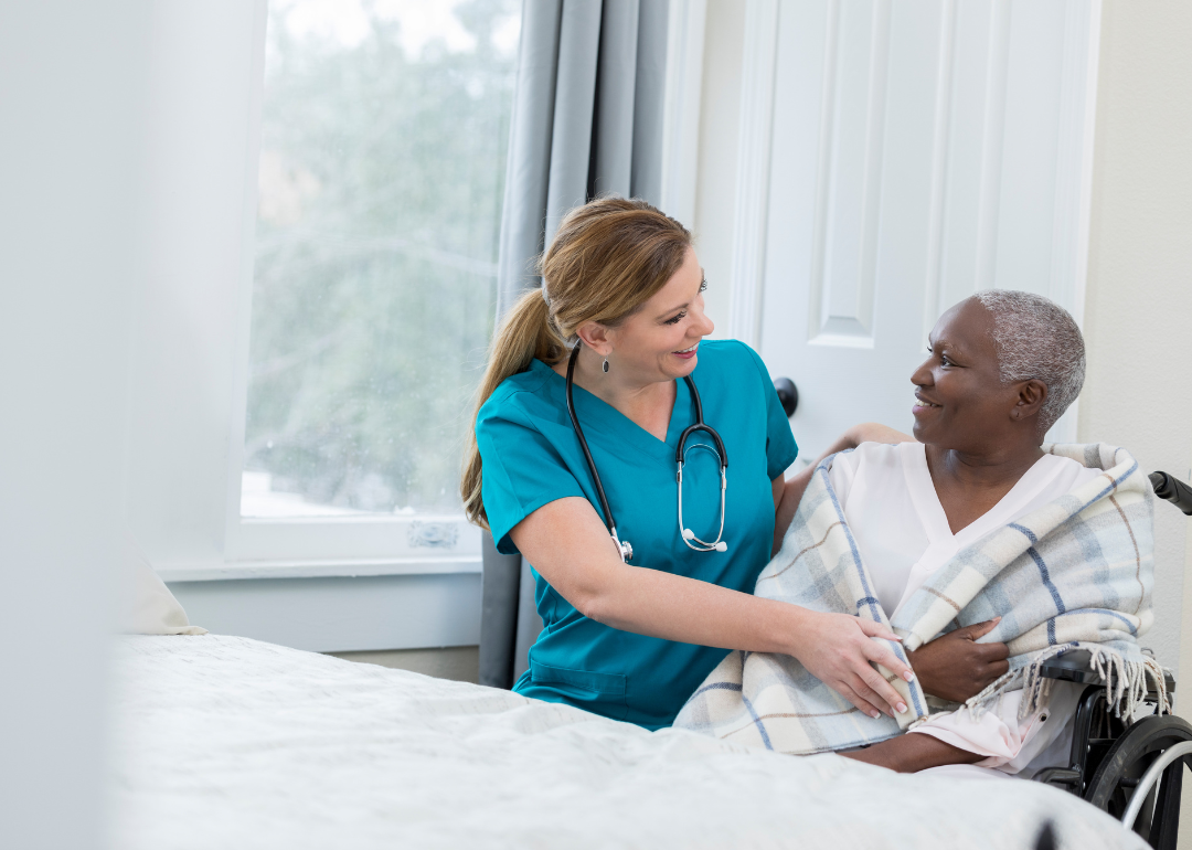 A nurse assisting a patient at a nursing home.