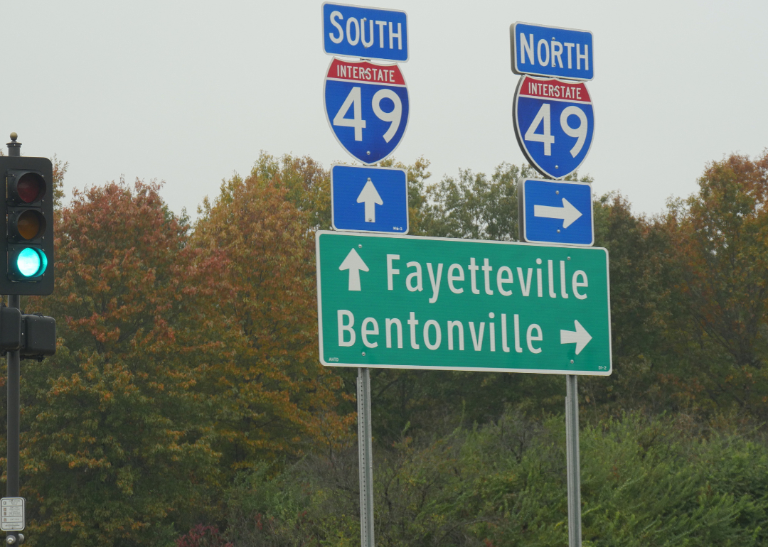 Roadside signs and directions to Fayetteville and Bentonville along Interstate 49 in Arkansas.