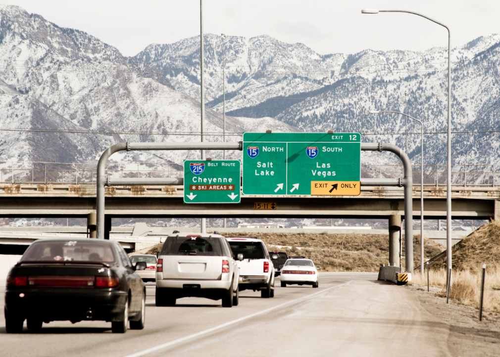 Traffic on a highway with the snowy mountain peaks in the background. 