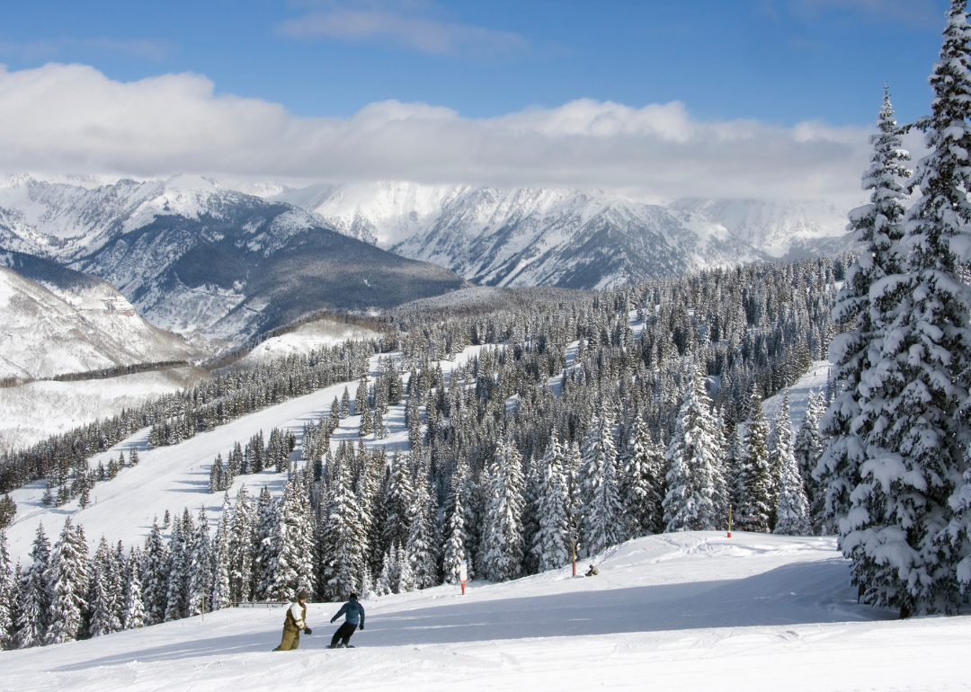 People snowboarding on the mountain in Vail.