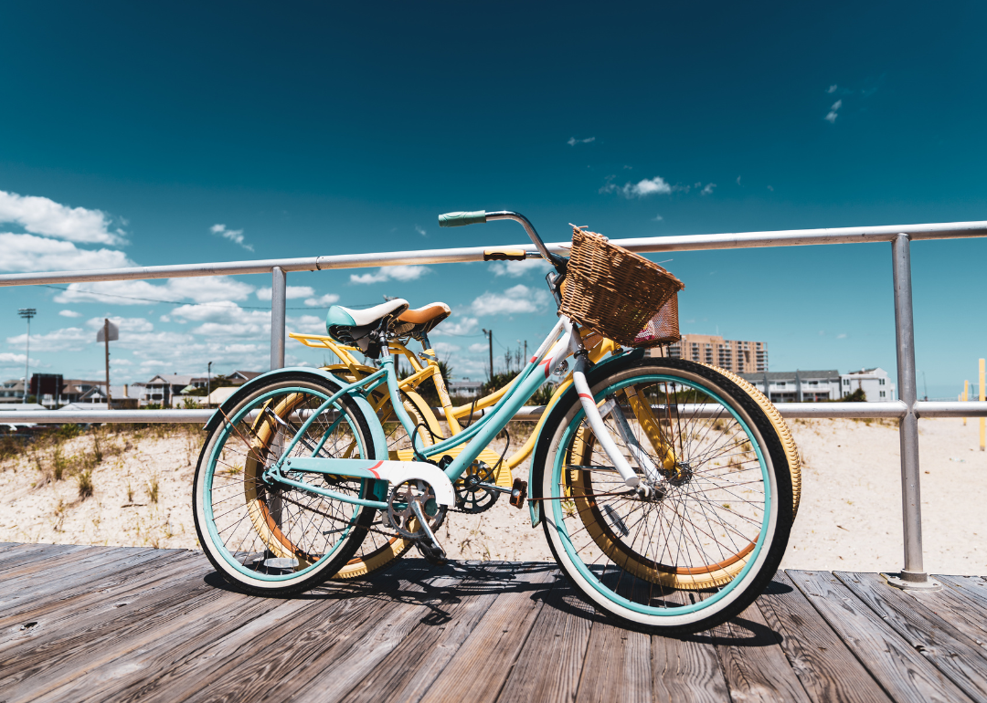 Pastel bicycles on the boardwalk at the beach.