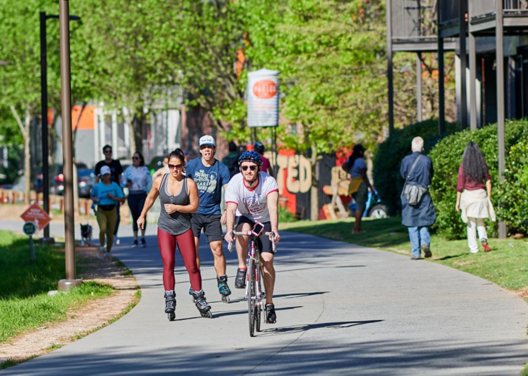 People biking and rollerblading on the beltline in Atlanta.