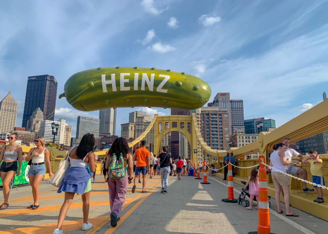 People walking on the Warhol bridge in Pittsburgh.