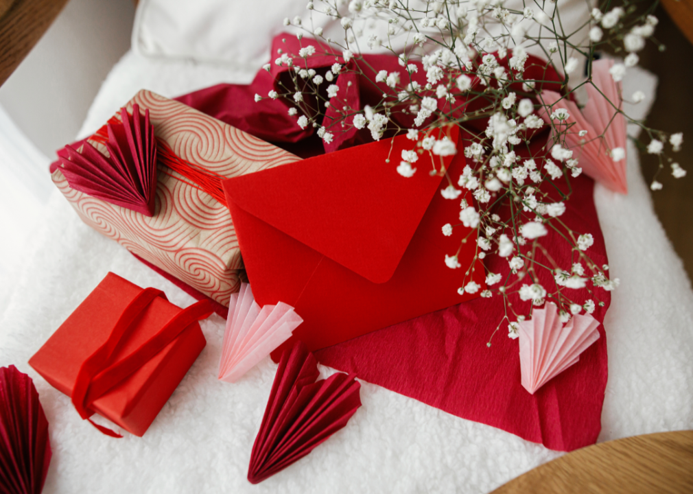 Wrapped gifts, a red envelope, and white flowers.