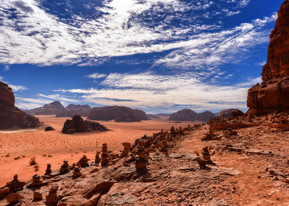 Bright orange desert landcape with rock formations and bright blue sky. 
