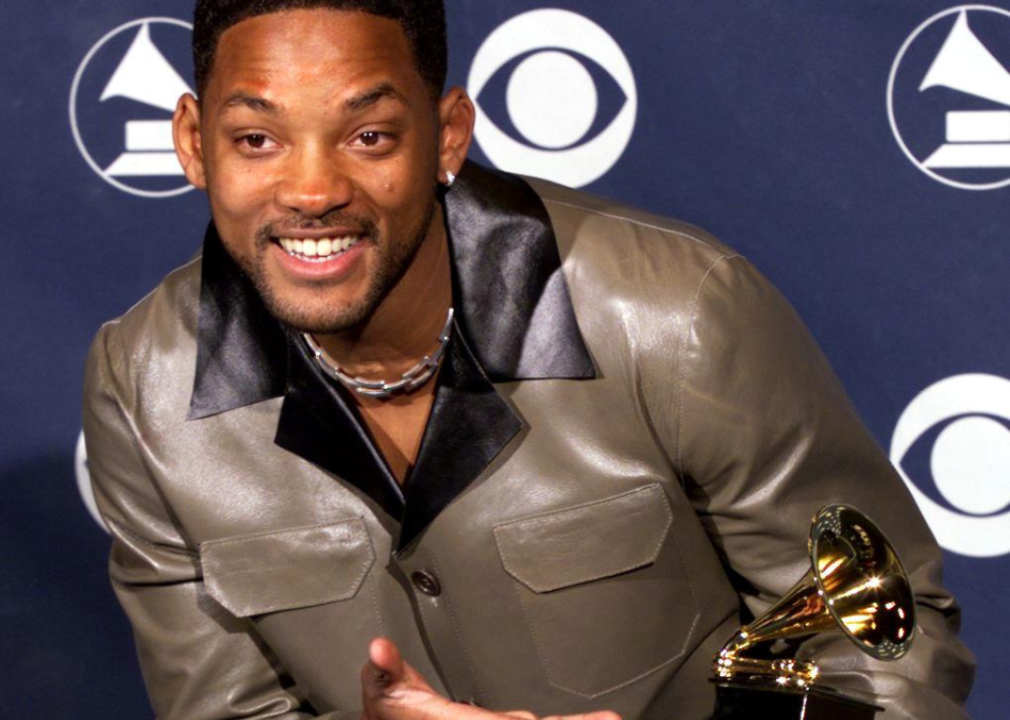 Jiggy Will Smith posing with a Grammy Award.