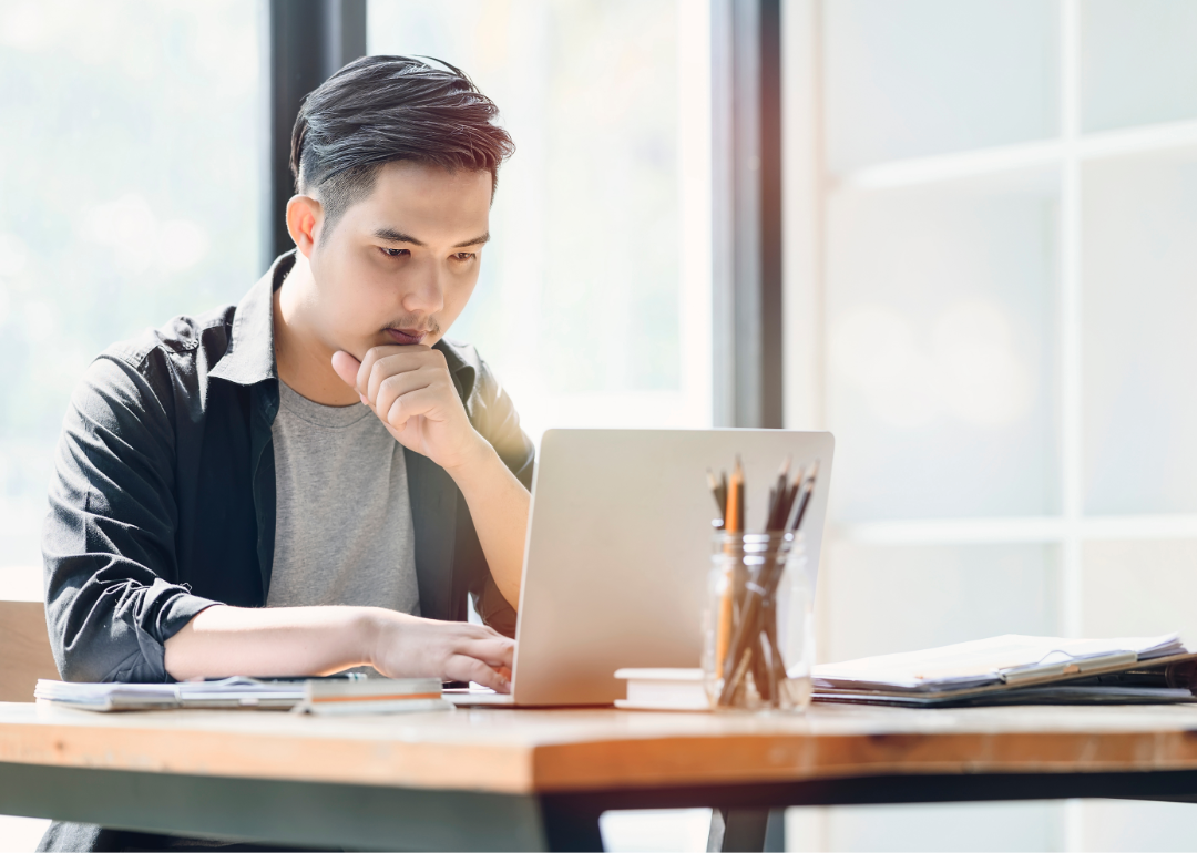 A student looks intently at a laptop.