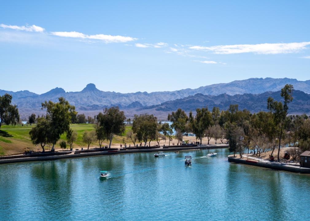 Boats on a lake with mountains in the background.