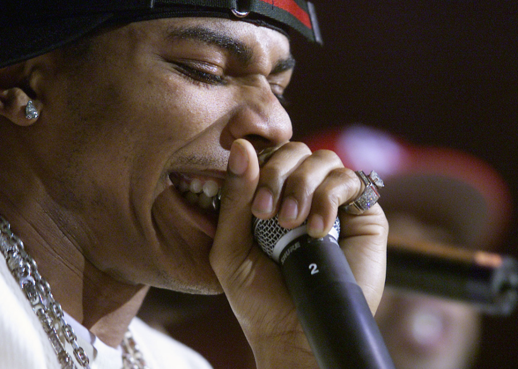 Closeup of Nelly holding microphone onstage.