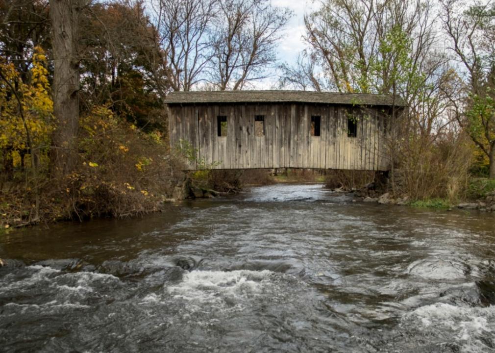 A covered bridge over a river.