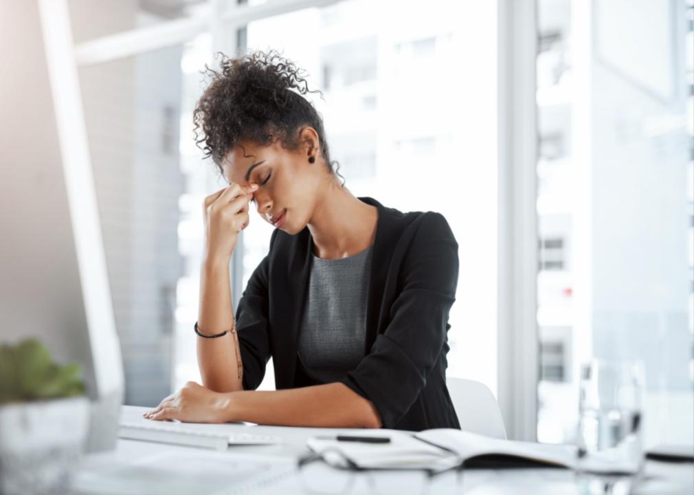 A stressed woman at a desk.