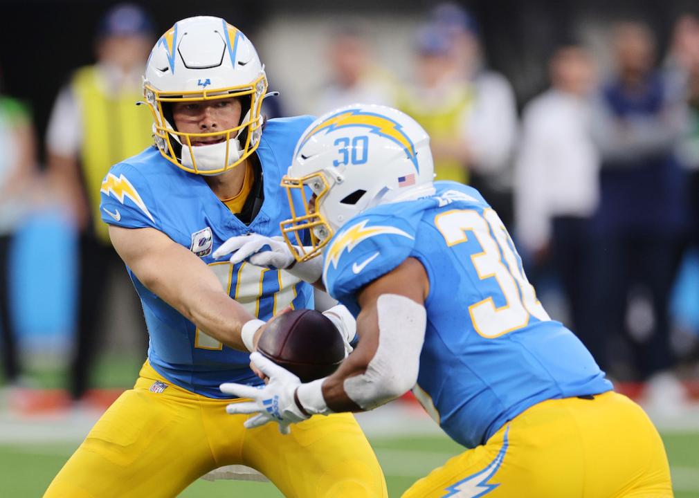 Justin Herbert hands off to Austin Ekeler of the Los Angeles Chargers in the first half against the Dallas Cowboys at SoFi Stadium on Oct. 16, 2023 in Inglewood, California.