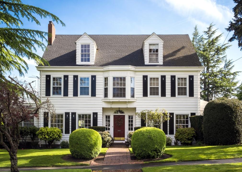 A classic American white home with black shutters.