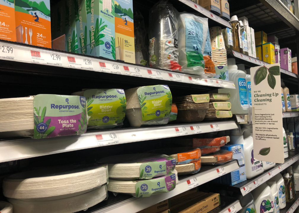 Compostable plates, cups and utensils on the shelves at a store.