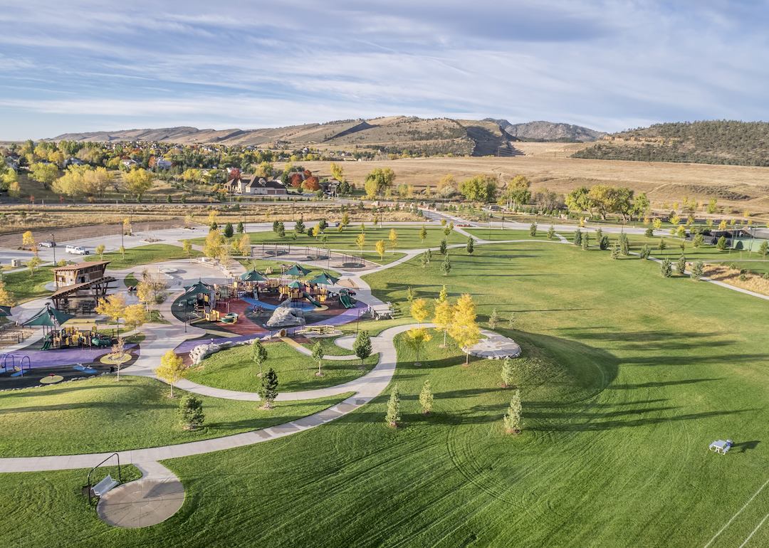 An aerial view of a park and homes in the background.