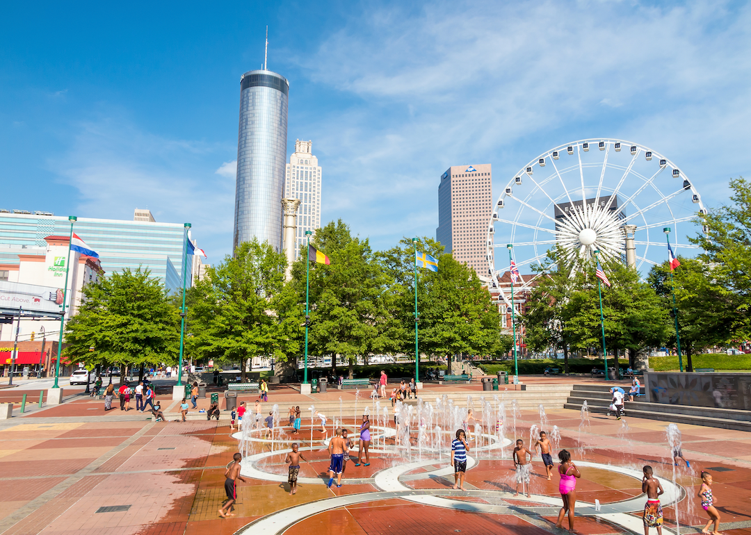 A splash pad and ferris wheel in downtown Atlanta.