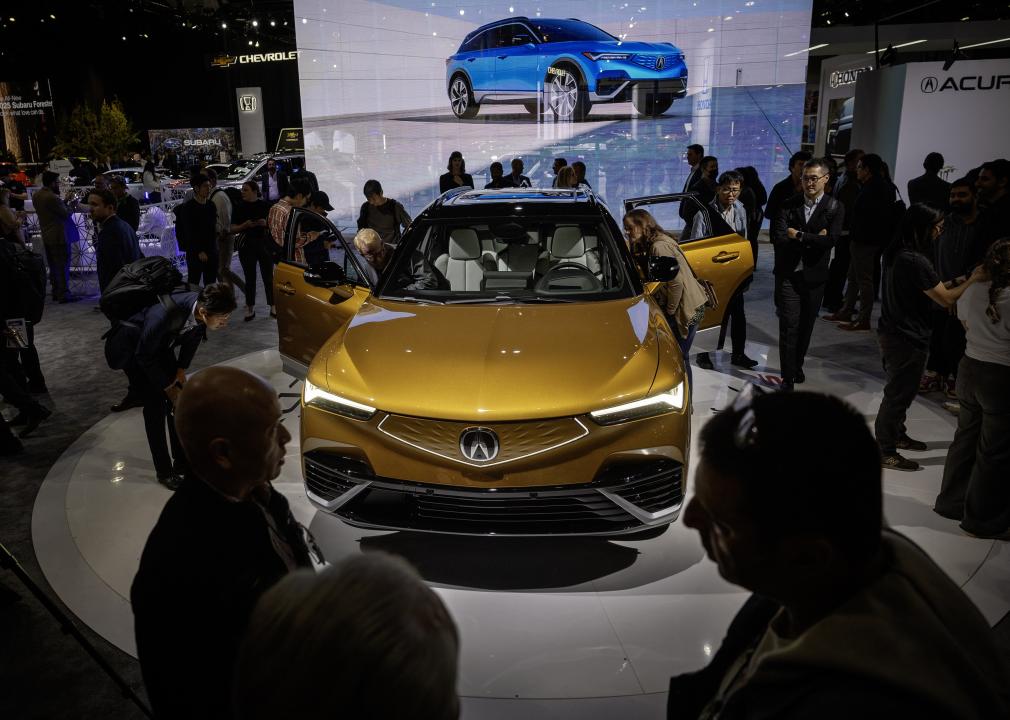 A gold Acura in a showroom.