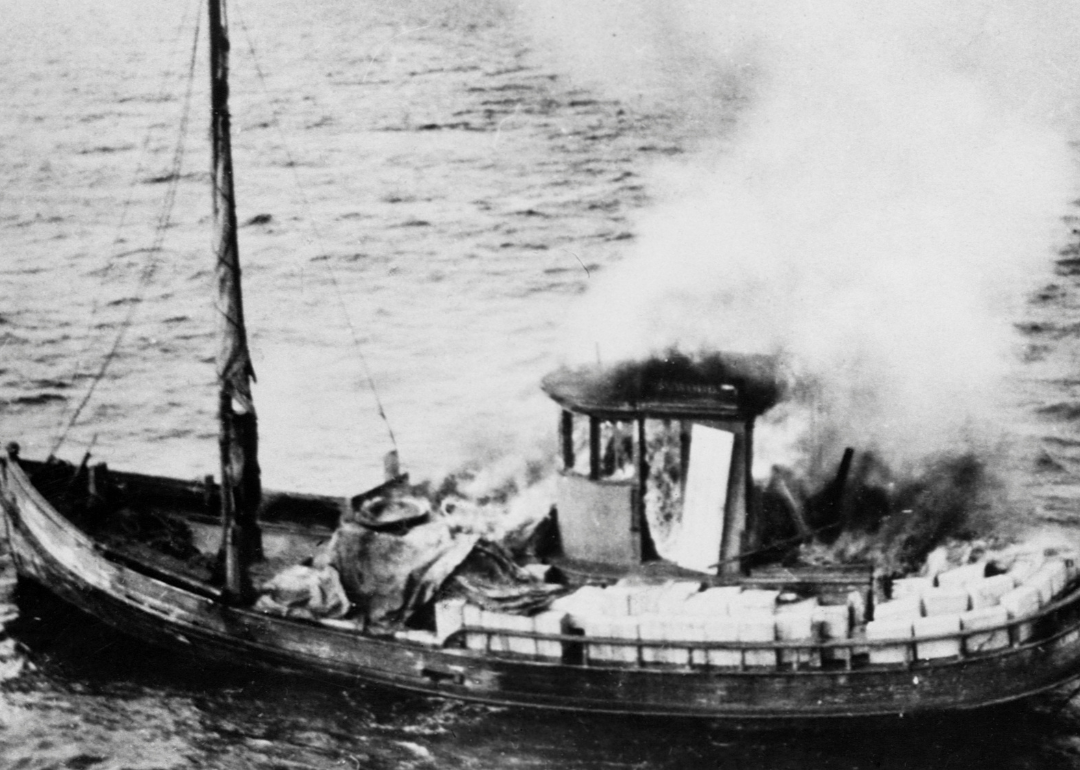 A rum runner boat set fire by crew before Coast Guard arrives.