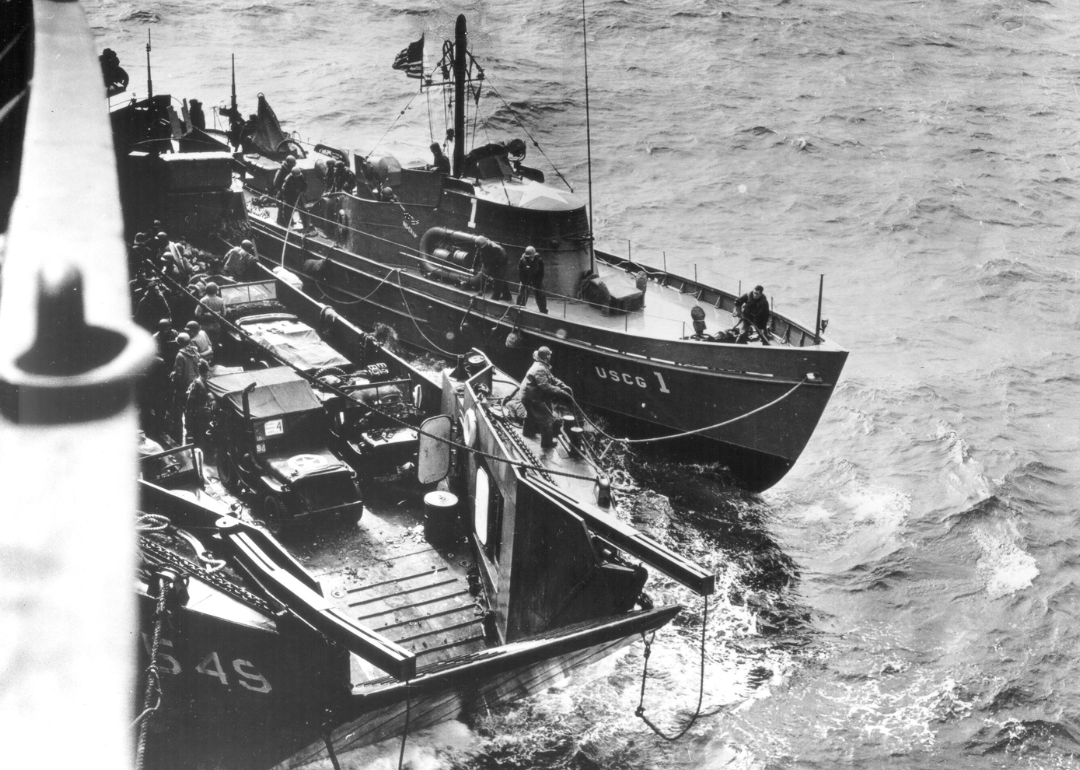 A Coast Guard boat tied up to another boat on D-Day.
