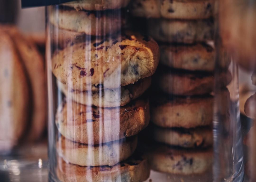 A plastic clear container of chocolate chip cookies.