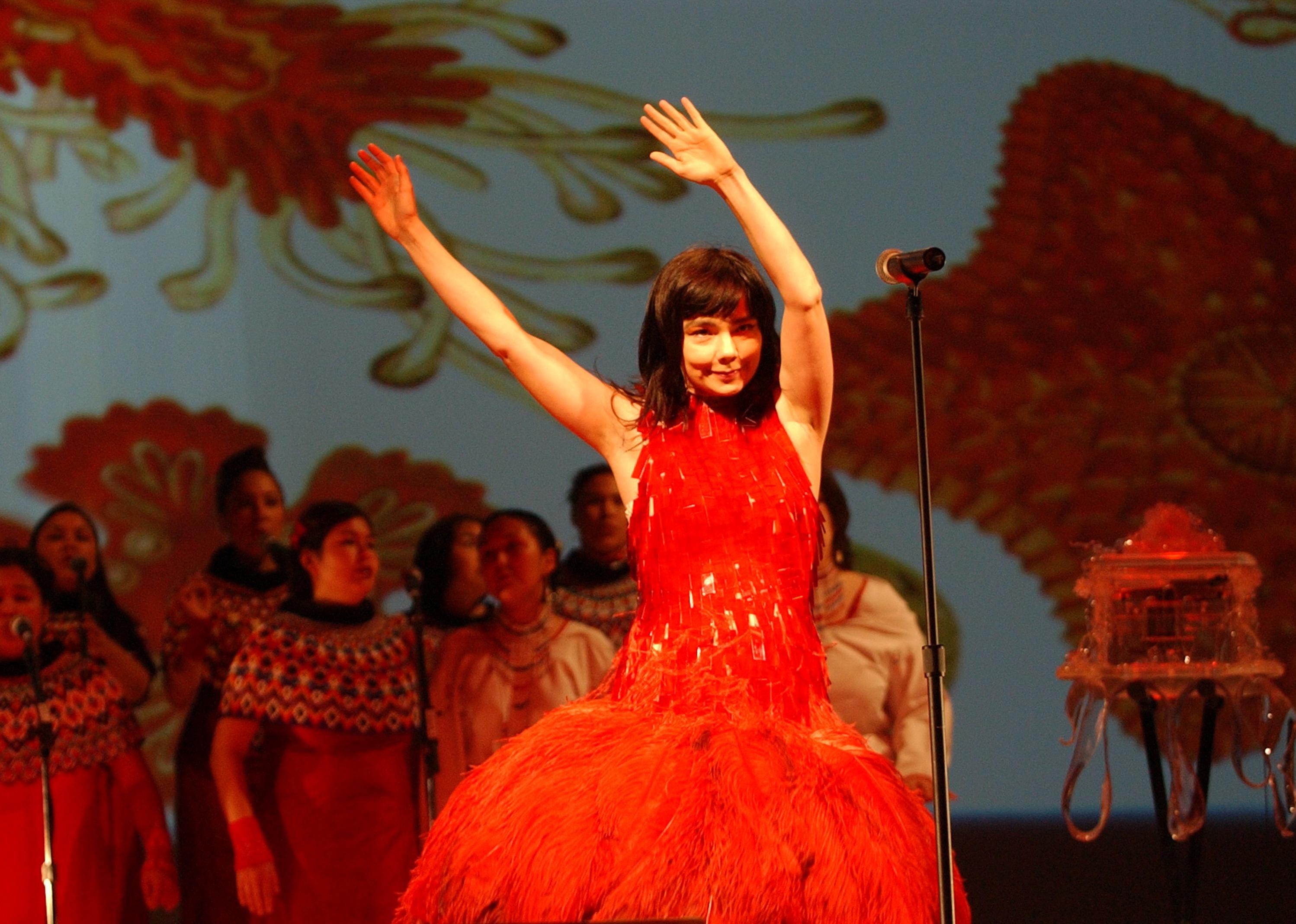 Bjork performs in a red dress onstage