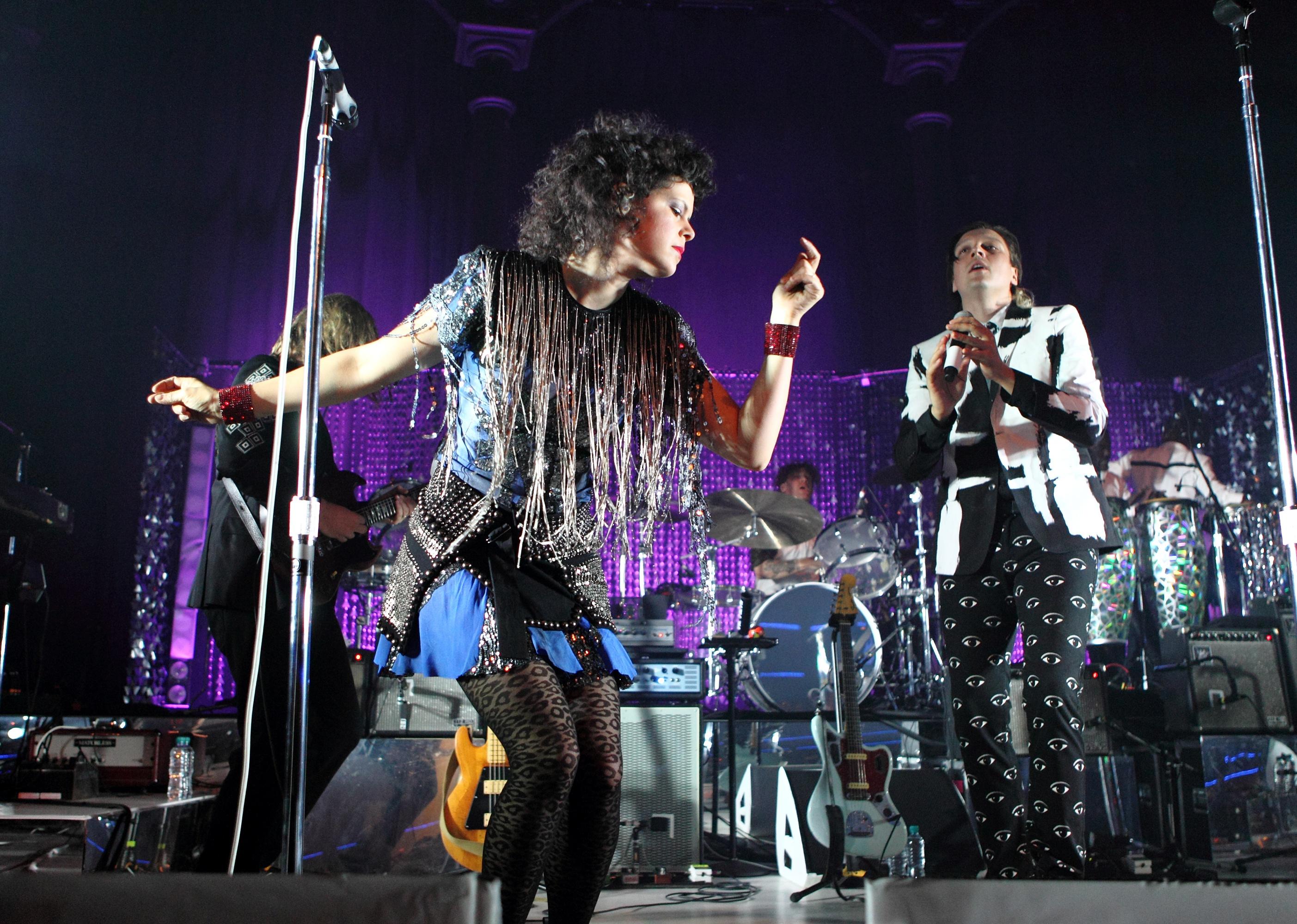 Arcade Fire performs at a concert