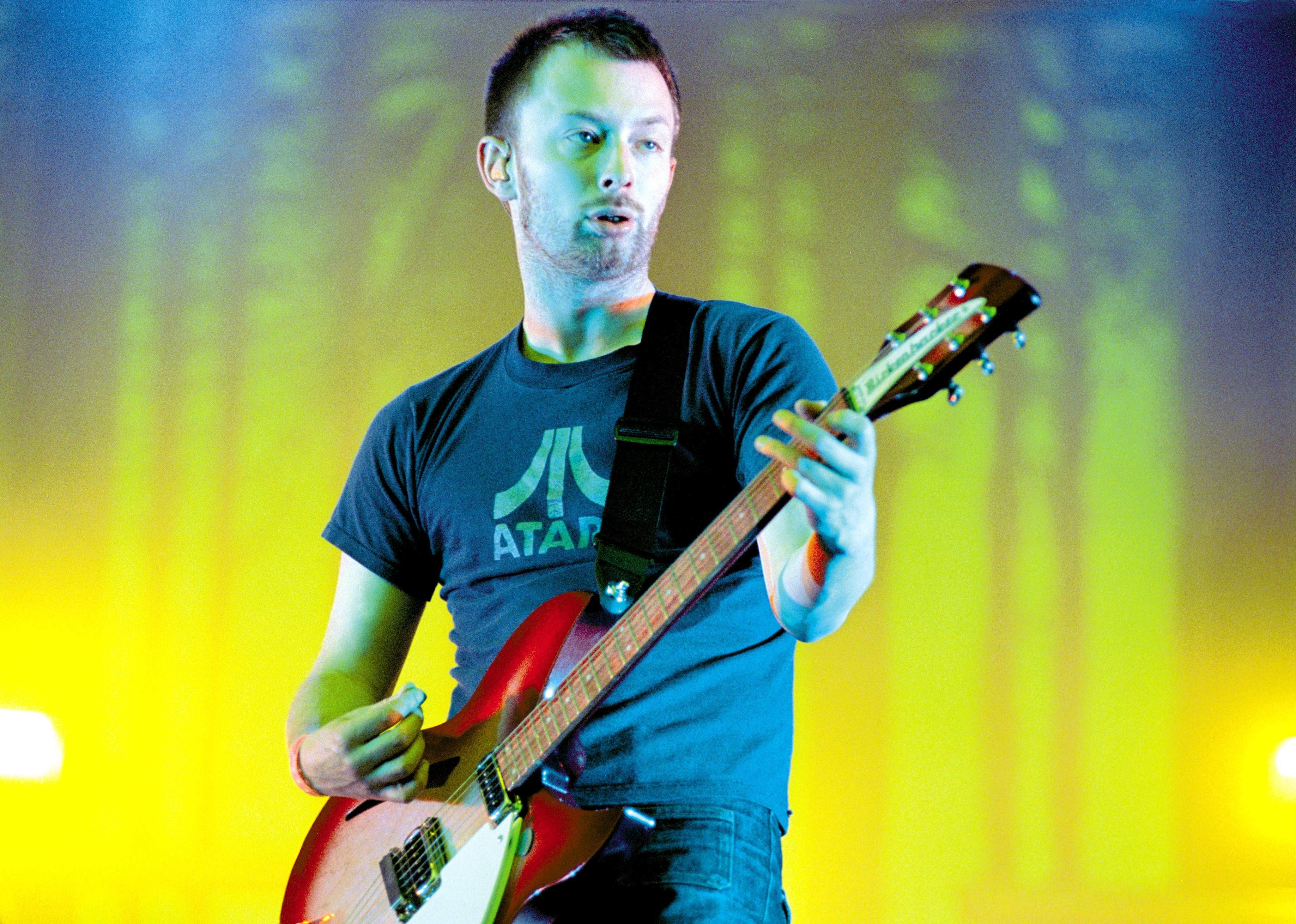 Thom Yorke of Radiohead plays a guitar