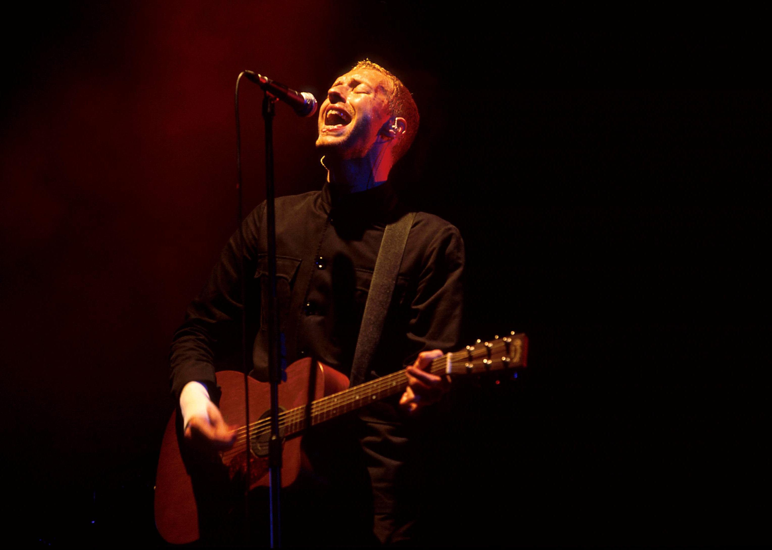 Chris Martin of Coldplay sings a song