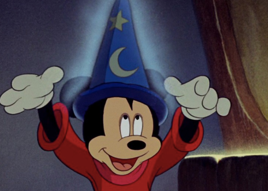 Mickey Mouse wearing a wizard hat.