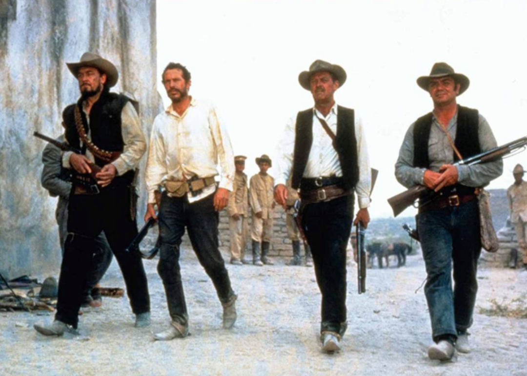Four cowboys walking in a line.