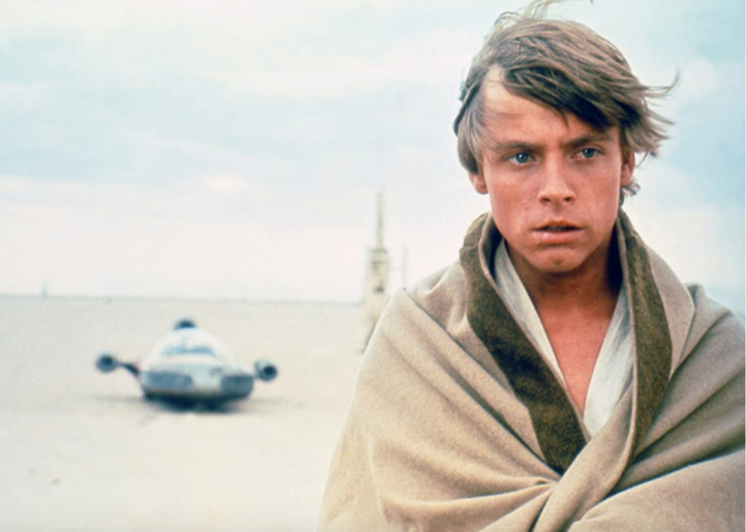 Mark Hamill in the desert wrapped in a blanket.